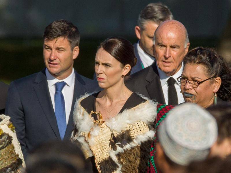 NZ Prime Minister Jacinda Ardern (C) arrives for a remembrance service for mosque attack victims.