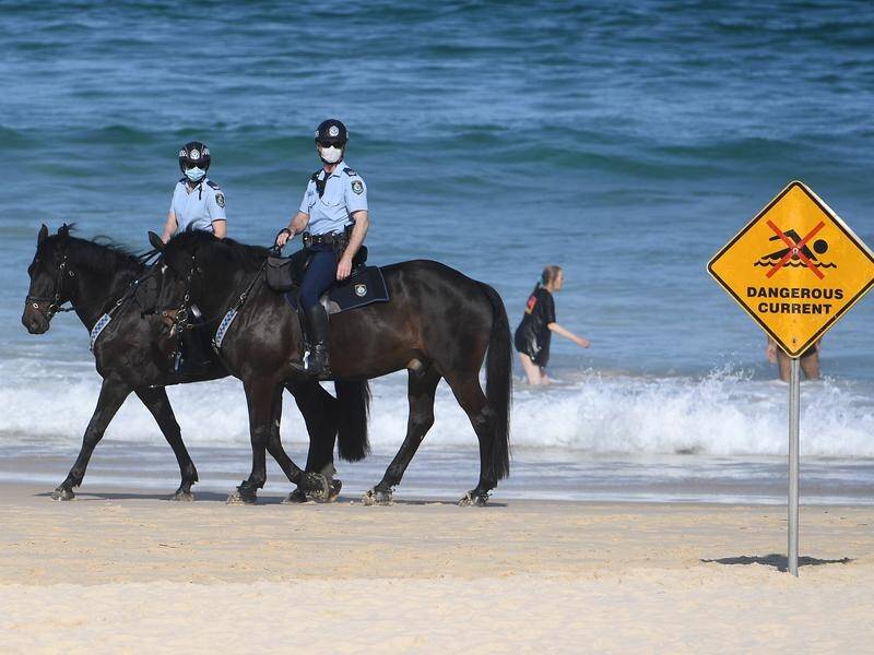 Police patrolling Bondi Beach on horseback in Sydney.