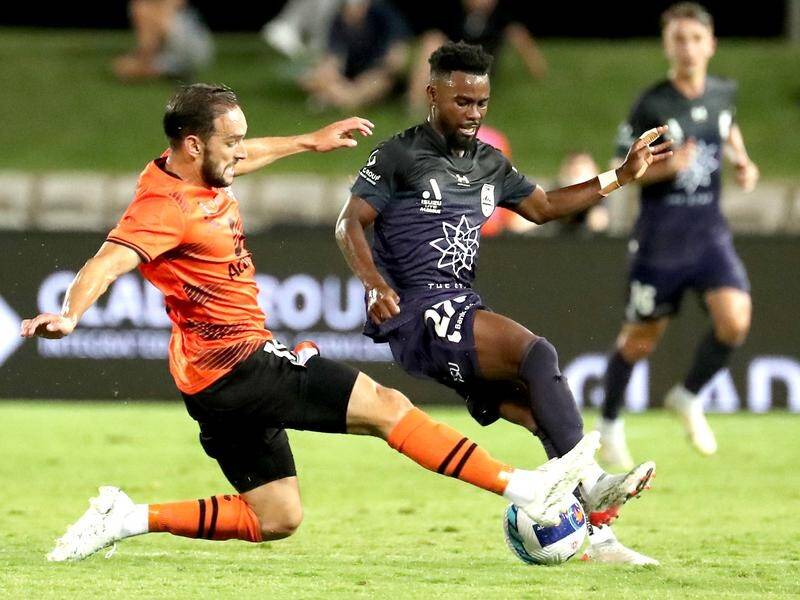 Sydney FC's Elvis Kamsoba is tackled by Brisbane Roar's Jack Hingert in their A-League meeting.