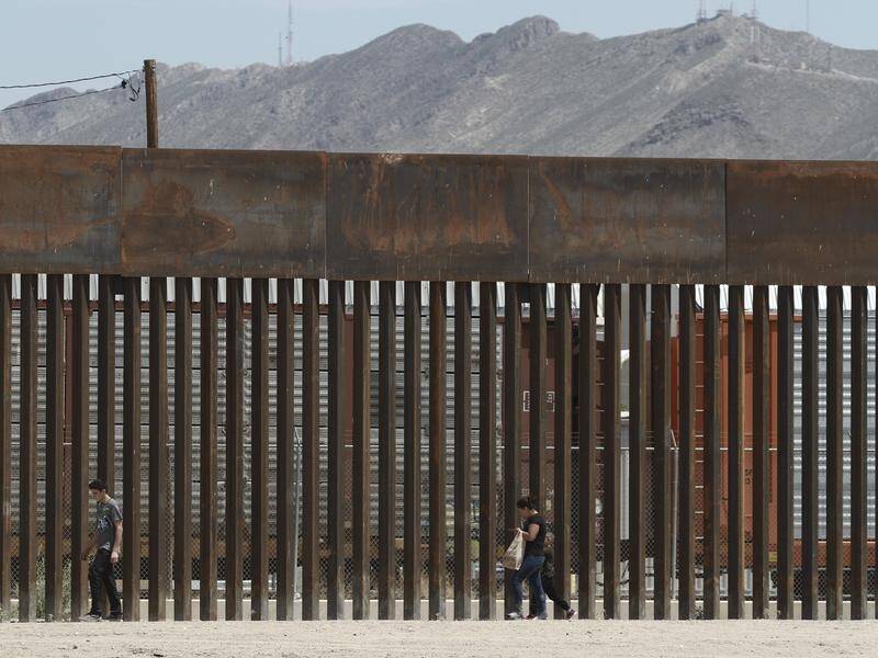 Migrants have cut through US President Donald Trump's "virtually inpenetrable" border wall.