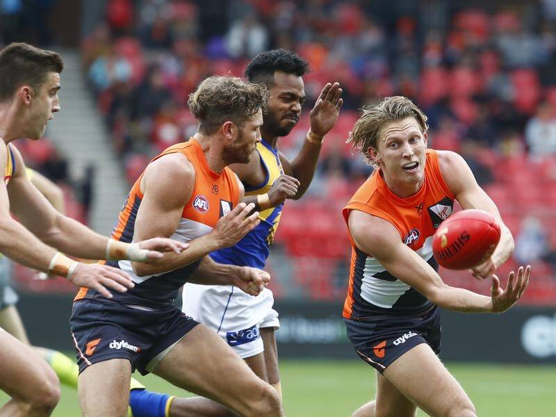 GWS's Lachie Whitfield (right) is set to play his 100th game for the Giants on Saturday.