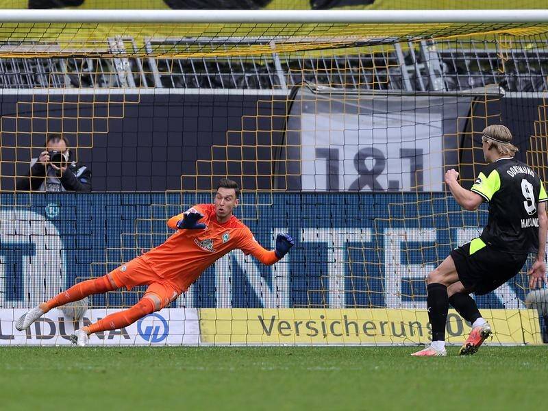 Erling Haaland scores from the penalty spot in Dortmund's 4-1 hammering of Bremen.