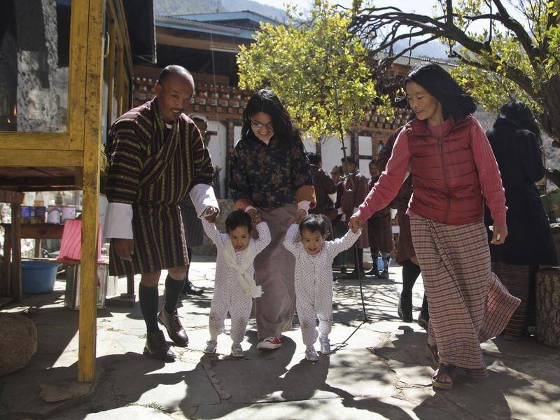 It was a joyful return to Bhutan for conjoined twins Nima and Dawa after surgery in Australia.