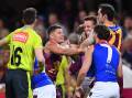 Lions' Dayne Zorko (L) gets into a scuffle during the AFL hammering by the Demons at the Gabba. (Jono Searle/AAP PHOTOS)
