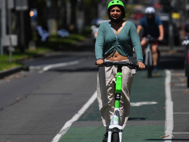 Victorians can ride their own e-scooter on the road from age 16 after a trial extension. (James Ross/AAP PHOTOS)