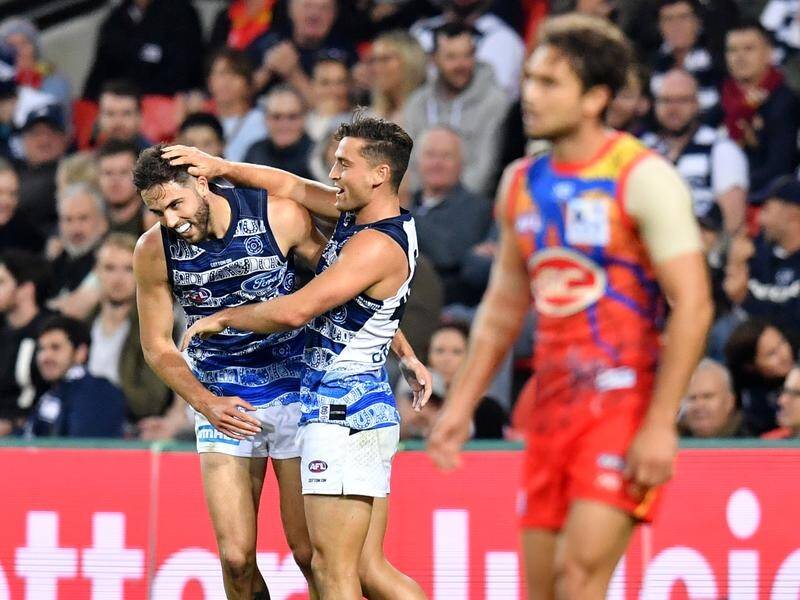Table-topping Geelong have subdued the Suns by 27 points in a tough AFL clash on the Gold Coast.