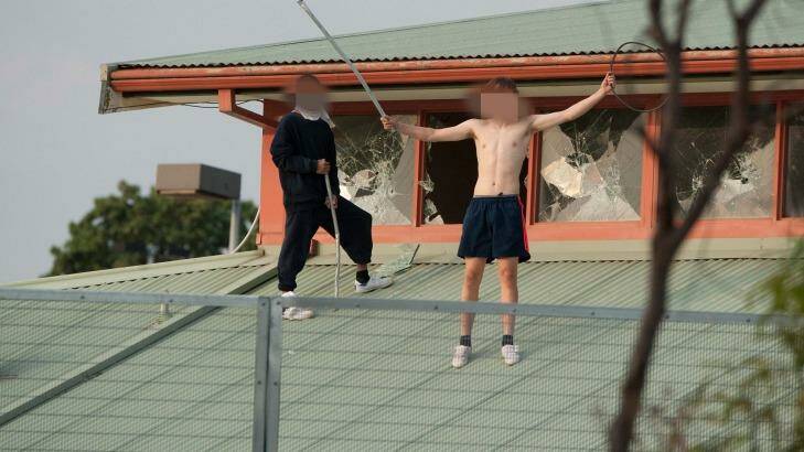 Youths protesting on the roof of the Parkville youth justice centre in March. Photo: Jesse Marlow
