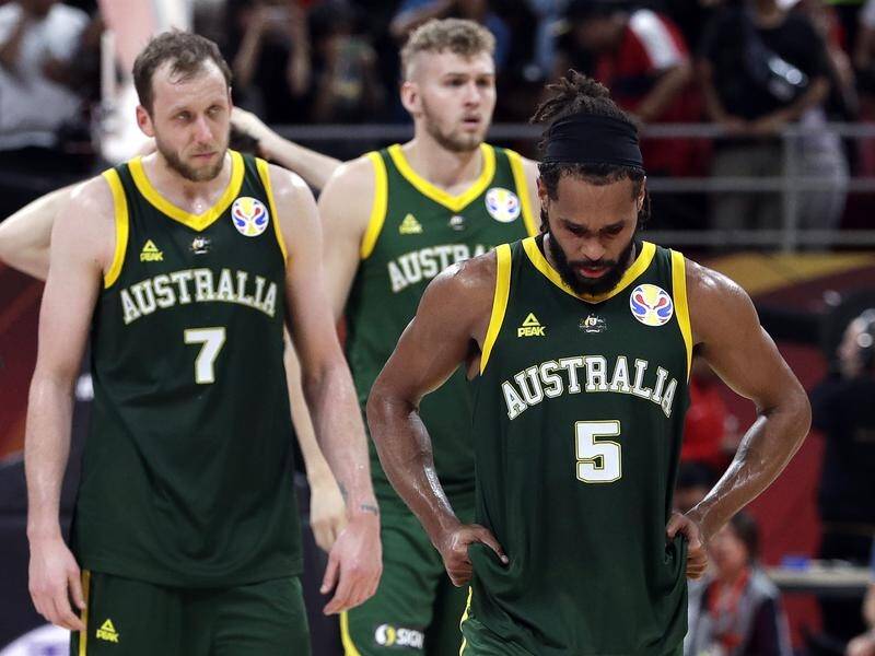 A shattered Patty Mills (c), Joe Ingles (l) and Jock Landale after the Boomers loss to Spain.