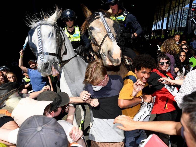 A climate protester has been taken to hospital after being injured by a police horse in Melbourne.