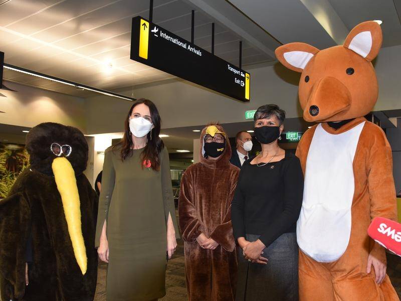 New Zealand's Prime Minister Jacinda Ardern and friends greet visitors at Wellington Airport.