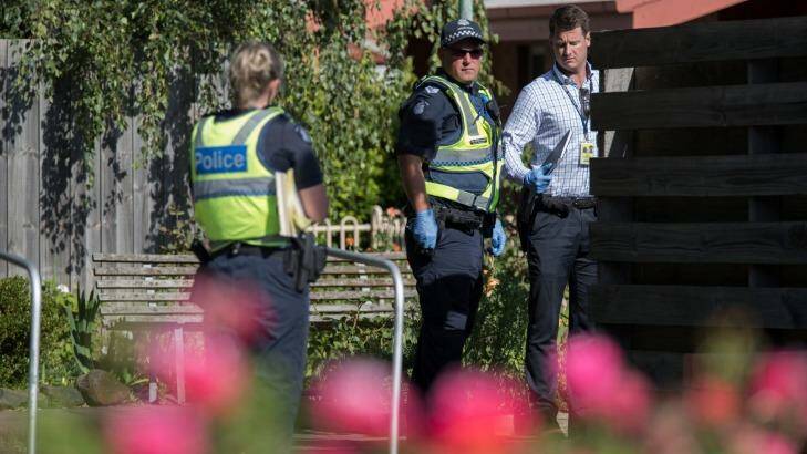 Detectives and police inspect the the scene of a body in the backyard of a unit in Seddon. Photo: Jason South