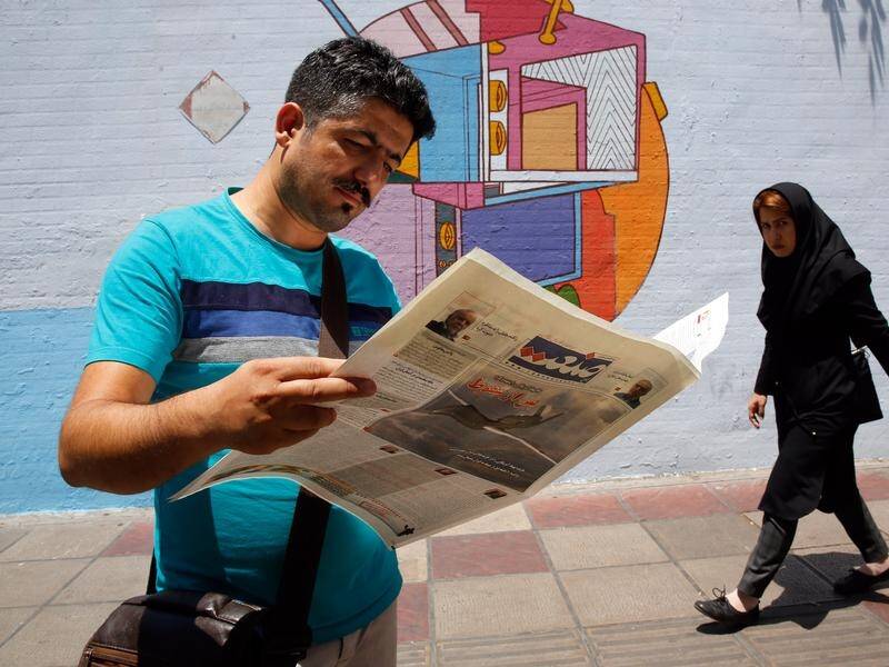 Iran's government says print editions of newspapers will be banned after April 8 to fight COVID-19.