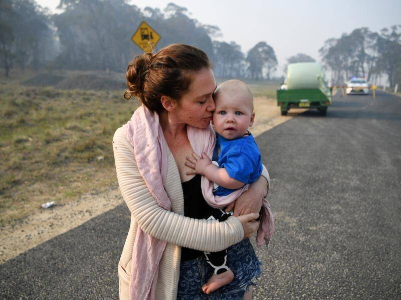 Wytaliba resident Storm Sparks and son Zeke Bacon had to wait as bushfires raged near their home.