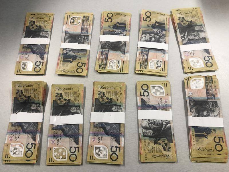 Police say $10,000 in counterfeit notes was discovered during a raid on a Gold Coast property.