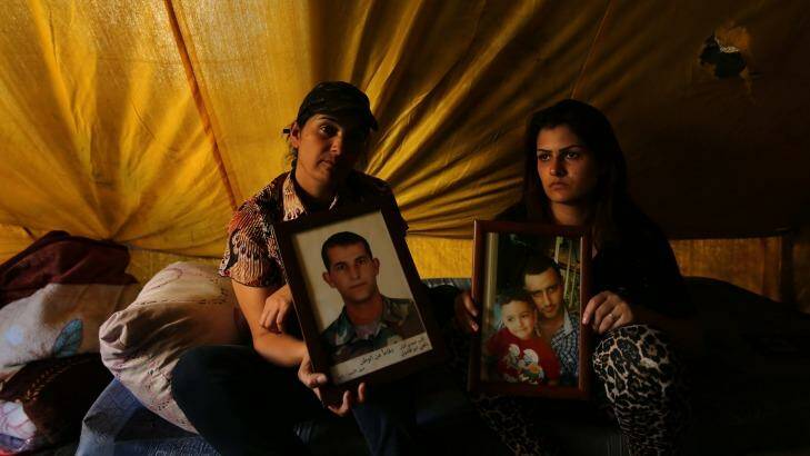 The families of captured Lebanese men, Darin Abu Kalfoni (left) holding a photo of her brother Nahi Abu Kalfoni, a soldier, and Hayfa Jaber holding a photo of her husband Maymoun Jaber. Photo: Kate Geraghty
