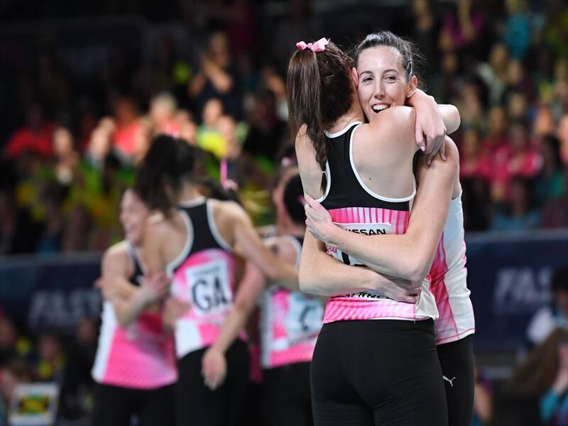 Bailey Mess (right) of New Zealand celebrates with teammates after winning the Fast5 netball title.