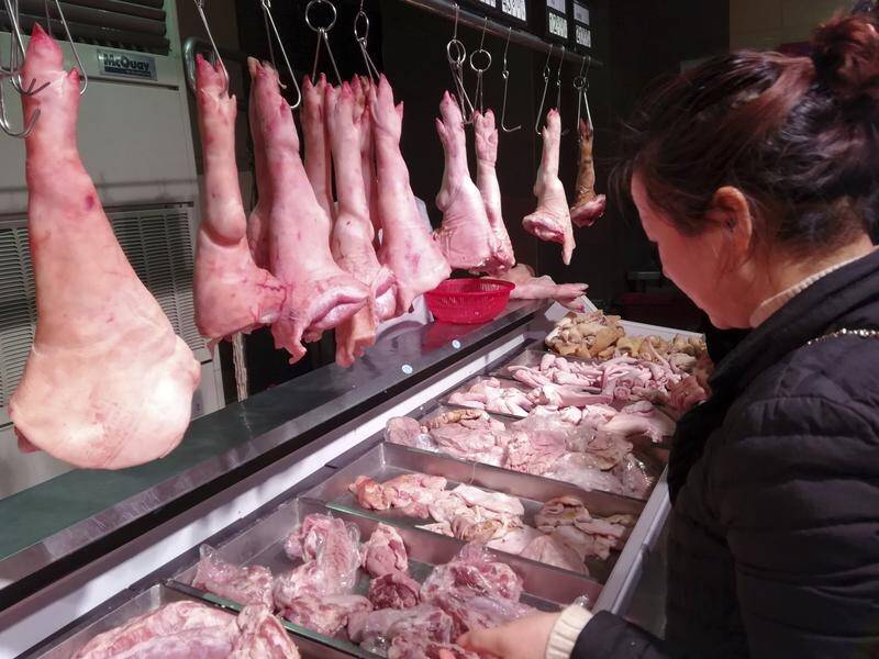 A customer shops for pork at a supermarket in Yichang city in central China's Hubei province.