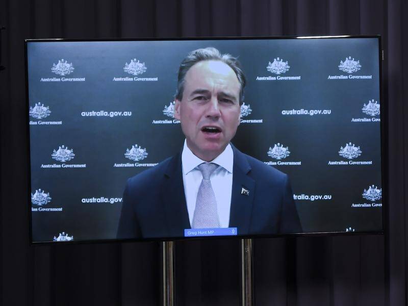 Greg Hunt says the wait for a booster shot will be reduced to four months from January 4.
