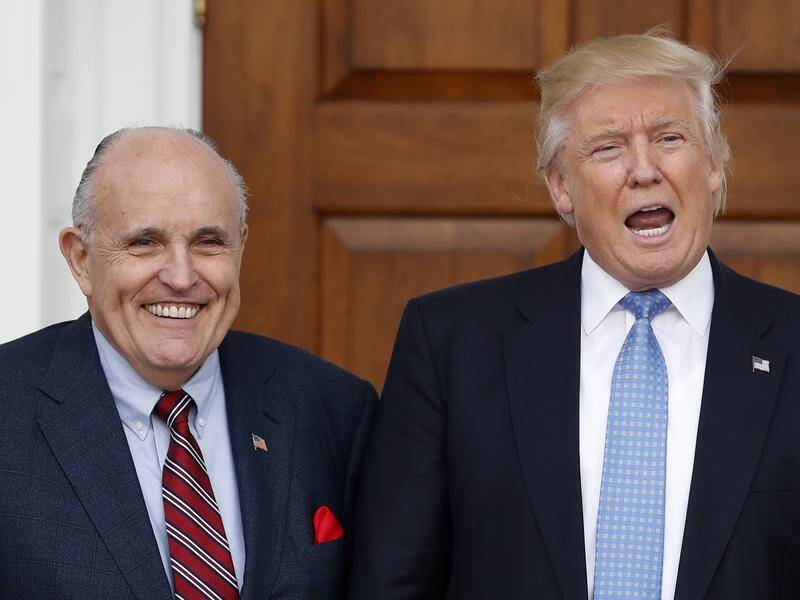 Donald Trump's lawyer Rudy Giuliani (L) says Americans would revolt if the president was impeached.