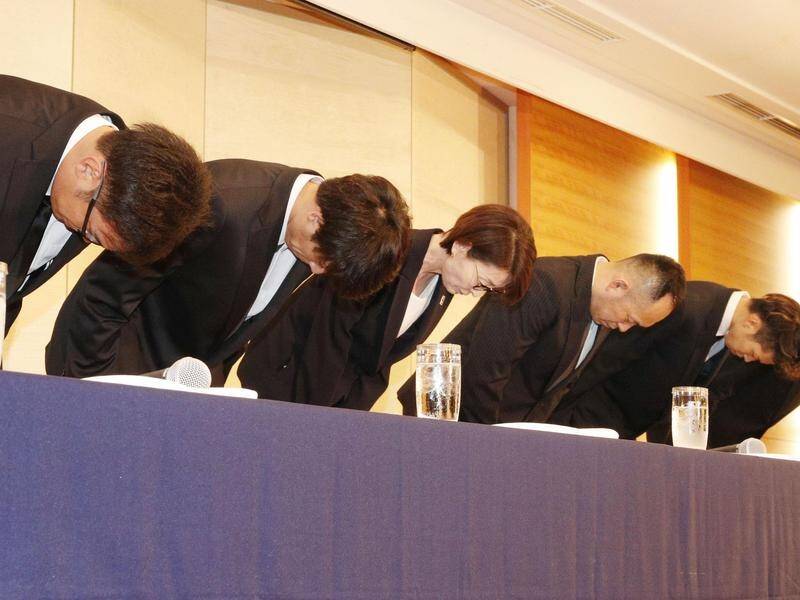 Japanese basketballers and officials bow in apology after players admitted to using prostitutes.