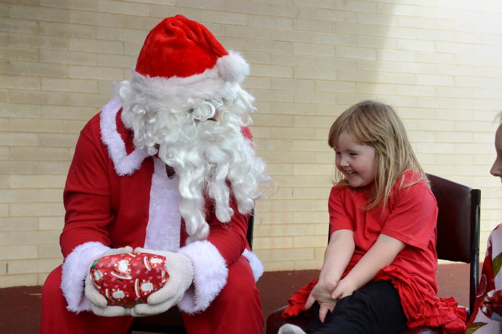 Isabella Brownlie from the Interchange LM U5 playgroup getting a present of Santa.

Picture: JIM ALDERSEY
111213
