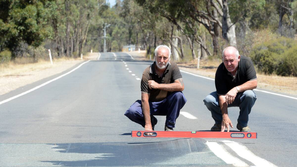 Peter Davey and Wayne Maher are unhappy that the road still hasnt been fixed.
A section of the Bendigo-Pyramid Hill road in Woodvale where the road is pushing up and creating a hazard to vehicles.

120213
Pb Jim Aldersey
