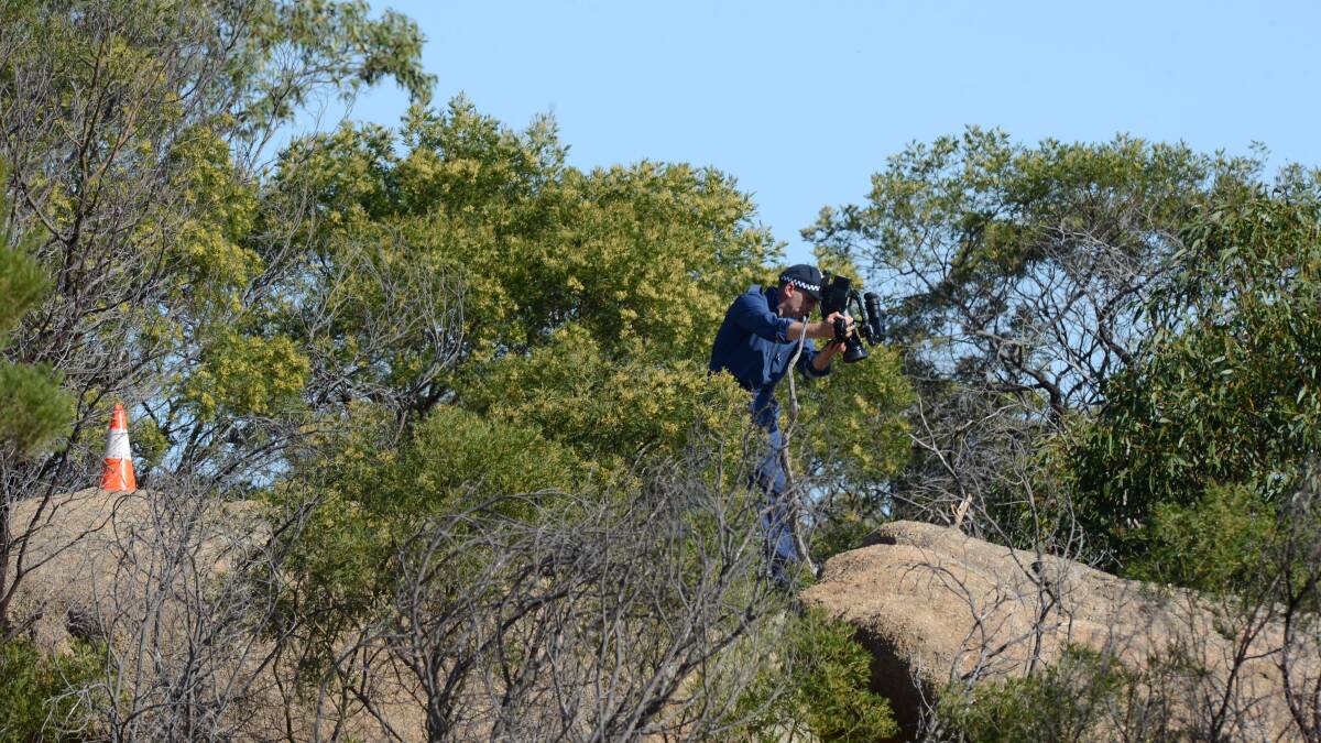 Police pull Wayne Amey's body from between two rocks on the summit of Mt Korong.

Picture: JIM ALDERSEY