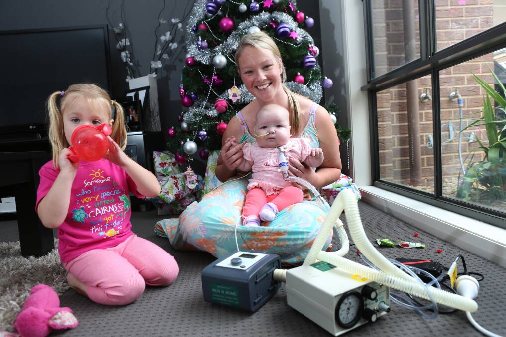 Isabella, baby Evie and mum Emily Stove. Picture: PETER WEAVING