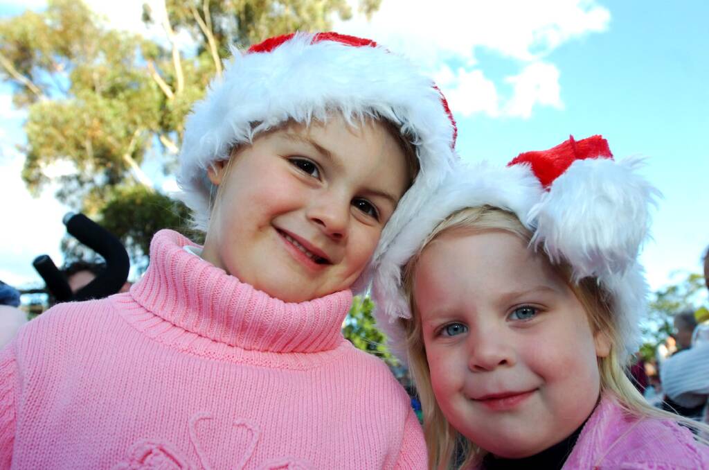 Jenna Cole (4) and Emily Strahan (3) at the Rotary carols by candlelight at Lake Weeroona. pic by Bill Conroy