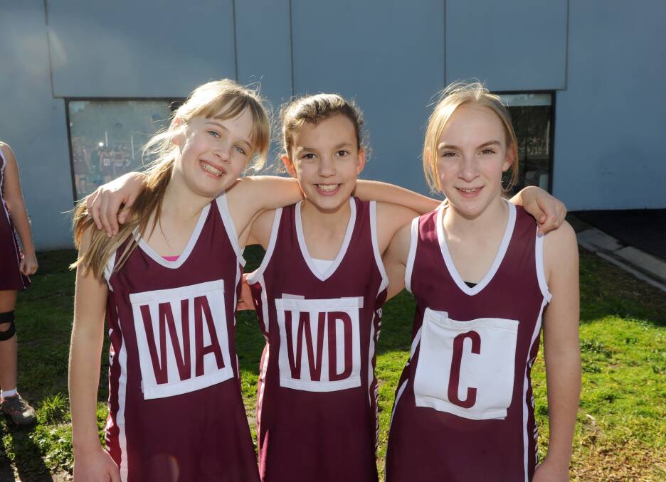 Strathfieldsaye PS team-mates Jemma Curnow, Macey Stephens and Georgia Vozlic take a break during the netball school championships at the Golden City netball courts. Picture: Jodie Donnellan