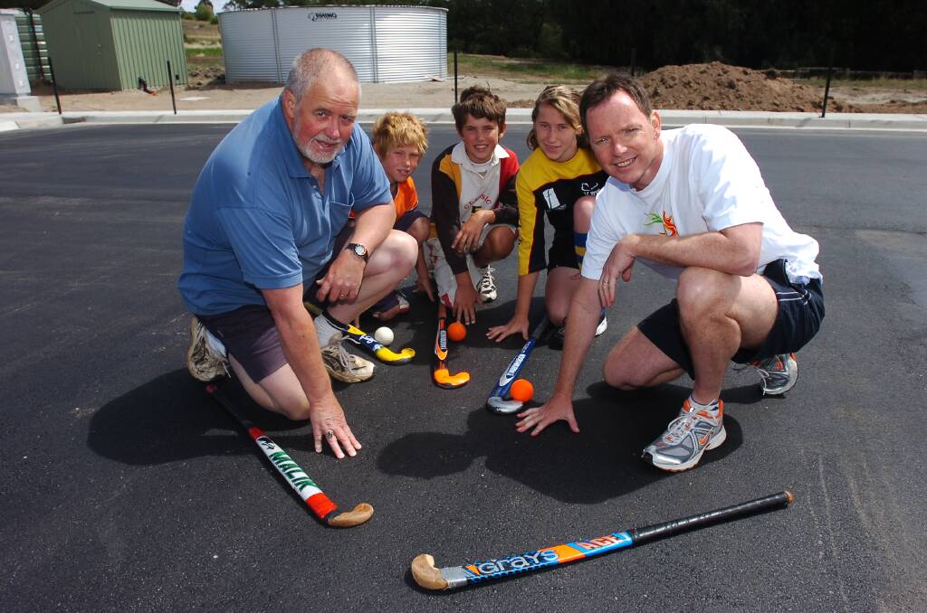  Julian Hood (Project Co-Ordinator) and Bob Cameron (Fed member for Bgo),with  Blake, Ridge and Jazmin Poyser at the new pitch with water tanks behind, the pitch will have a special surface put on soon at the Ashley st Hockey grounds. pic by Bill Conroy 