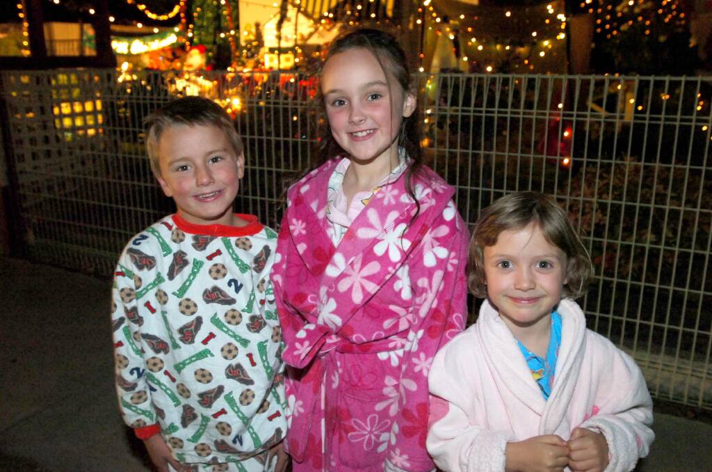 Mollie, Ned and Lydia Schiffregger outside the lights of 46 Sanhurst Road, braving the cold Bendigo night to enjoy the Christmas spirit. pic by Bill Conroy