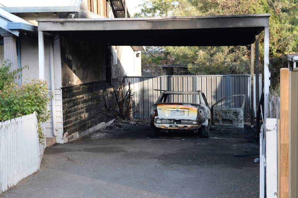 DESTROYED: The Arson Squad will investigate a suspicious fire that left a car burnt out, and damaged a carport and house in Bendigo early on Tuesday morning. Picture: JIM ALDERSEY
