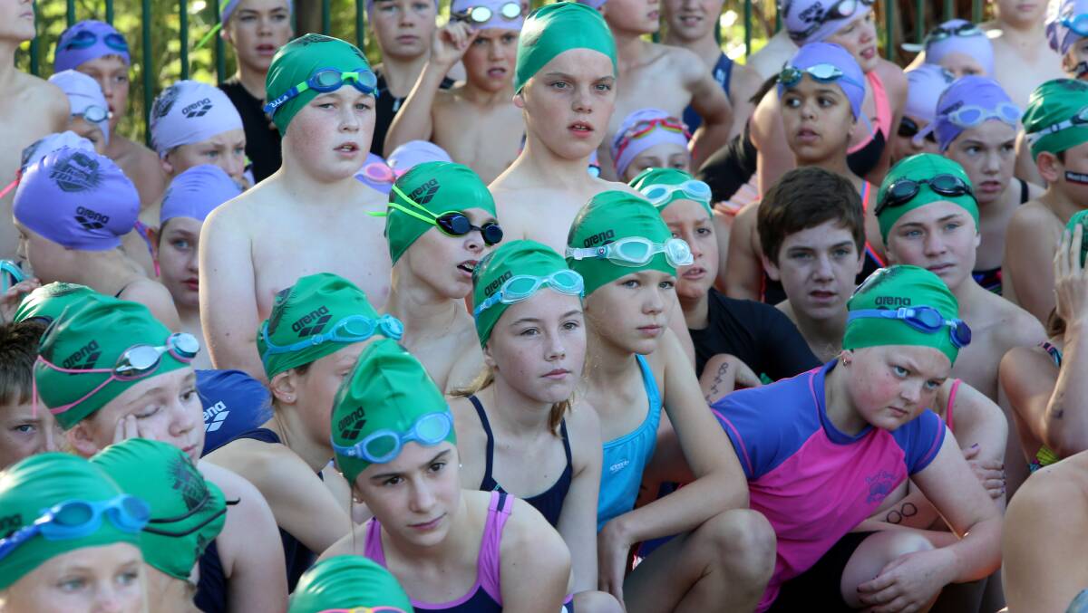 PREP: 11-15-year-olds get a briefing before starting the swimming leg of the TRYathlon. 