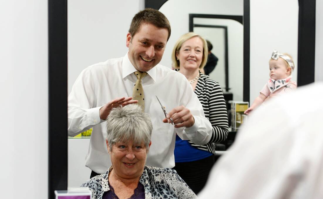 CHOP: Opposition leader Matthew Guy tries hairdressing at Coco Red Hair and Beauty in Maryborough. Picture: ADAM HOLMES