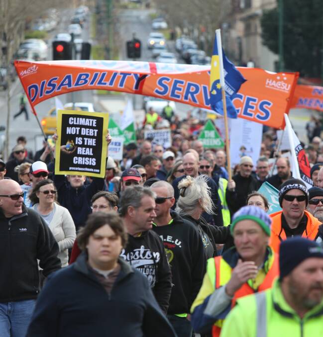 MARCHING: Protesters head south down Mitchell Street. Picture: GLENN DANIELS