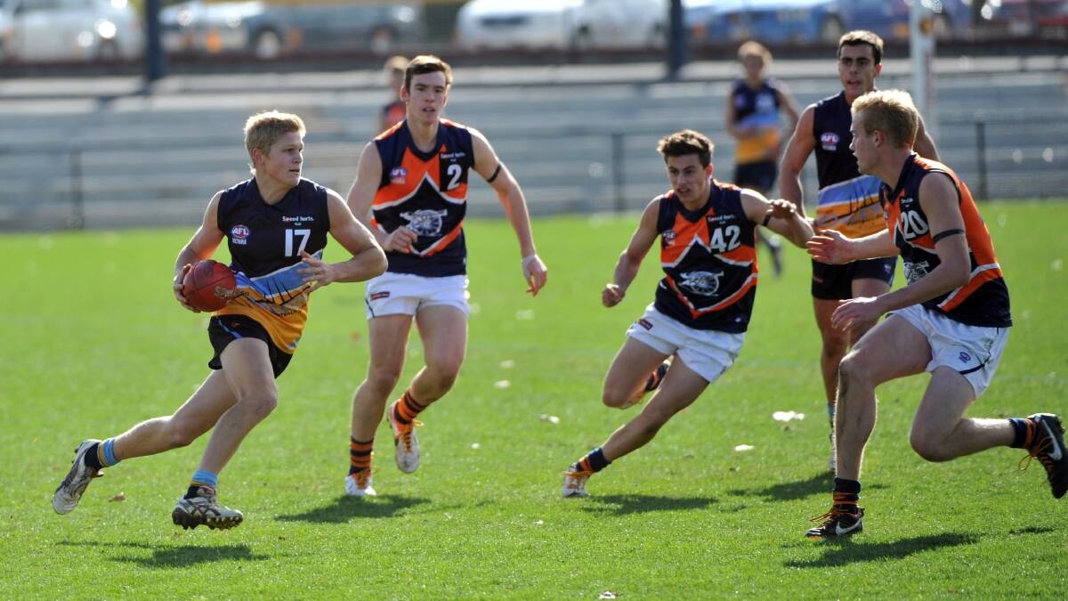 The pacy Harry O'Meara takes on three Calder Cannons opponents in the Pioneers win on the QEO in 2013. 