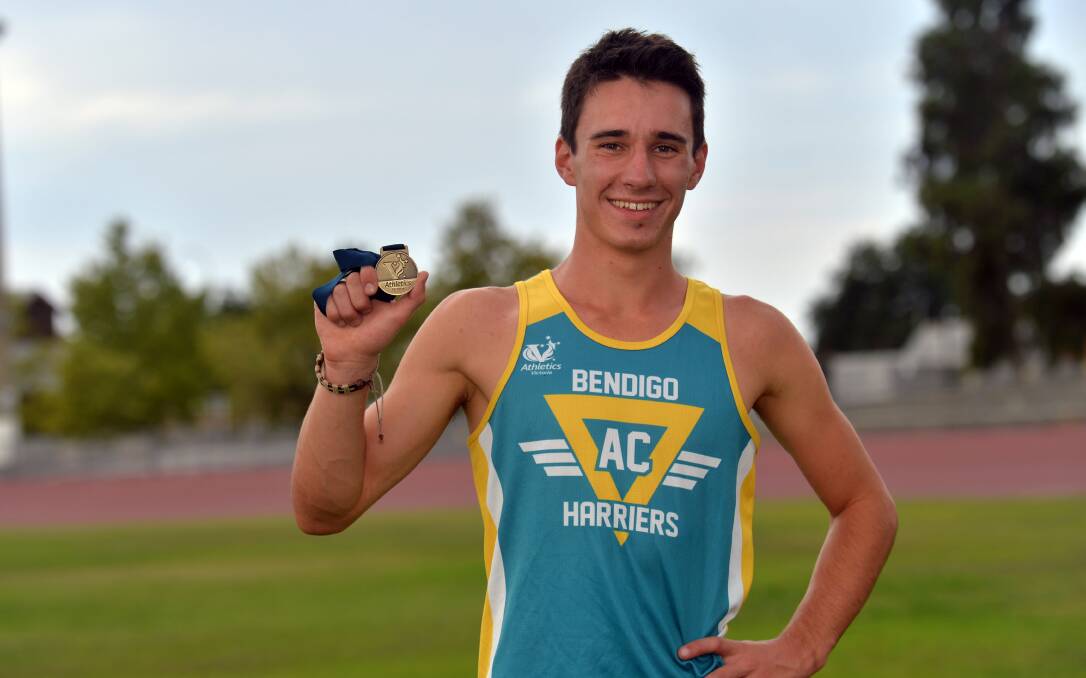 GOLD: Luke Rowlatt with the medal he won in the open 4 x 400m at the Victoria Country track and field championships in Ballarat. Picture: BRENDAN McCARTHY