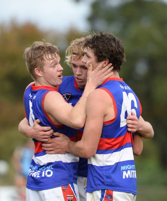 CELEBRATE: Ethan Minns, Patrick McKenna and MIchael Thornton after a Gisborne goal in Saturday's victory at Eaglehawk. Picture: LIZ FLEMING