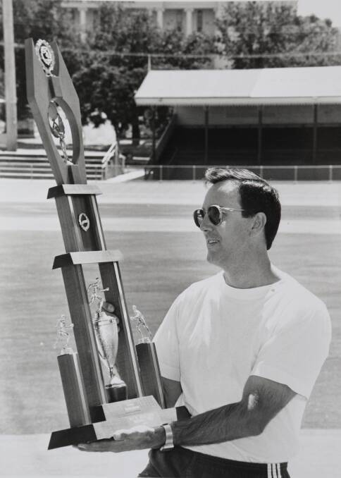 MEMORIES: Frank Cornish admires the trophy he won for being the Bendigo Thousand champion in 1979. This picture was taken in the lead-up to the 1994 Bendigo Madison athletics-cycling carnival. 