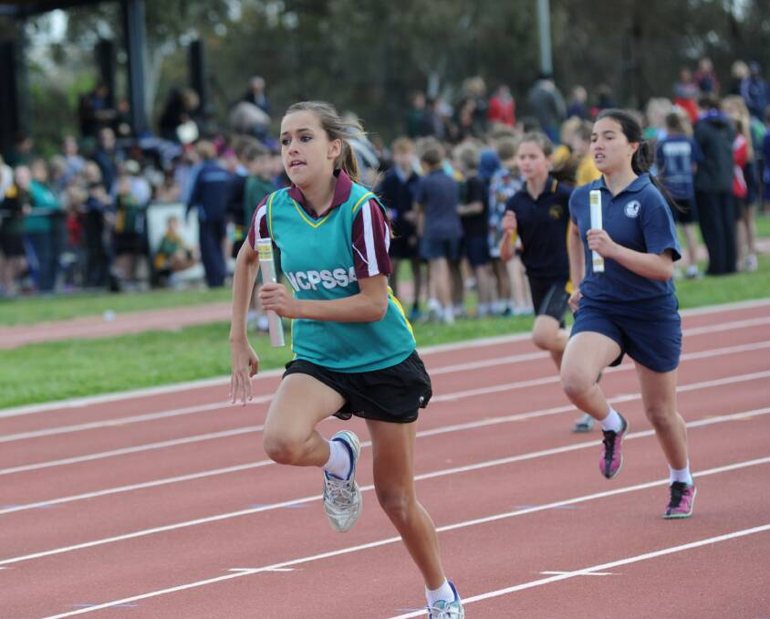 Brandy Cochrane from Echuca South Primary School competes in a relay at Monday's running of the Loddon Campaspe region athletics titles at Flora Hill. Picture: JODIE DONNELLAN 