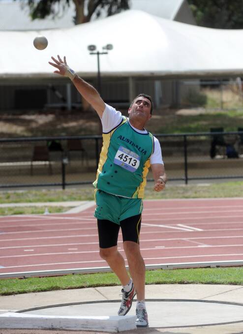 Stan Grant competes in the shot put. 