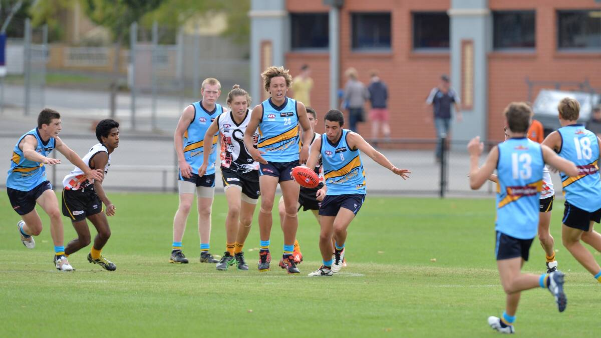 Lachlan Carroll from Tyntynder wins this centre break for Bendigo Pioneers in the under-16 country championships match against Dandenong Stingrays. 