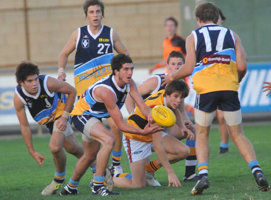 Jake Hall handpasses in the clash with Dandenong Stingrays at the QEO in 2008. 