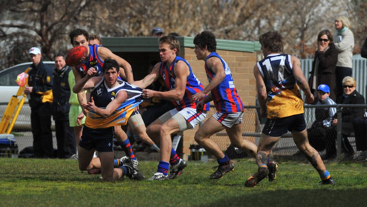 Jake Hall handpasses against Oakleigh Chargers in 2008 at Golden Square. 