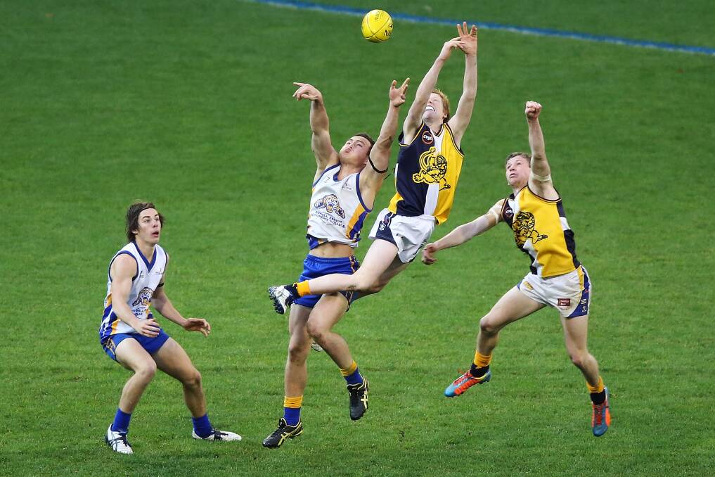 LEAP: Bendigo Senior SC’s Gedd Hommelhoff and Justin Bateson fly against Box Hill’s Marshall Sadkin in the premier league decider. Picture: GETTY IMAGES