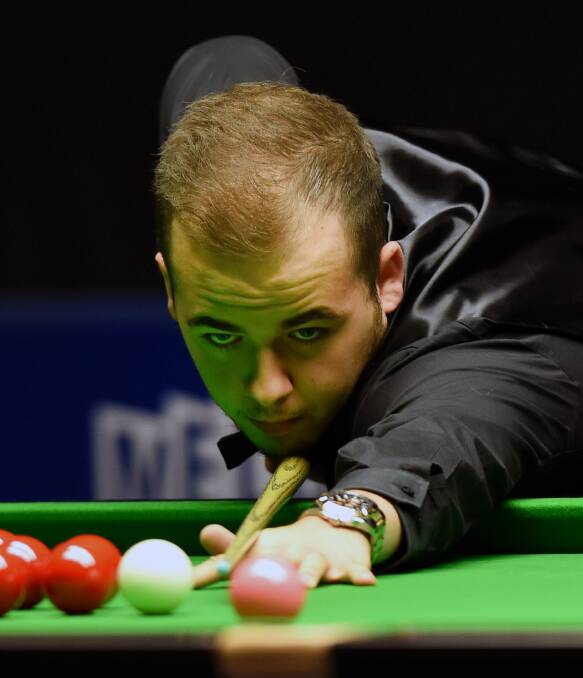 POT BLACK: Luca Brecel focuses on this shot in his first-round match against Matthew Stevens. 