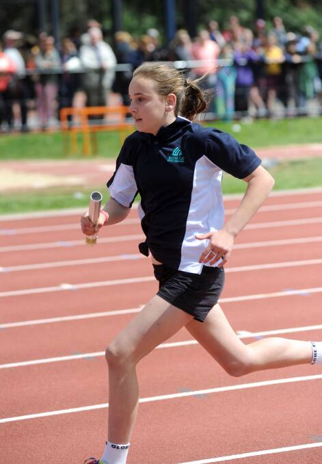 Rachelle McLean from Winters Flat runs in a relay. 
