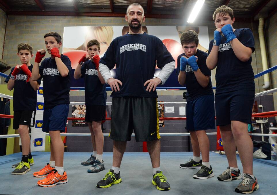 HANDS UP: Riley Osborne, Jacob Kofoed, Declan Osborne, Olympic boxer and now trainer Lynden Hosking, Liam Bentley and Cayden Sayle at Hosking's Boxing Gym in central Bendigo. Picture: BRENDAN McCARTHY