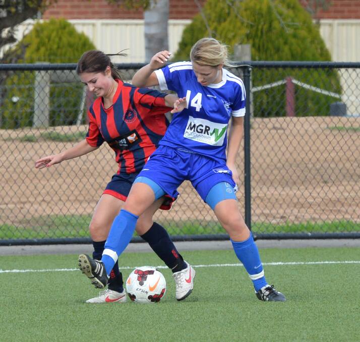 GREAT BATTLE: Epsom's Bianca Trimboli and Strathdale's Tayla Evans vie to win possession in the BASL championship match on the synthetic pitch at Epsom-Huntly Reserve. Picture: PETER WEAVING